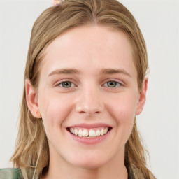 Joyful white young-adult female with long  brown hair and blue eyes