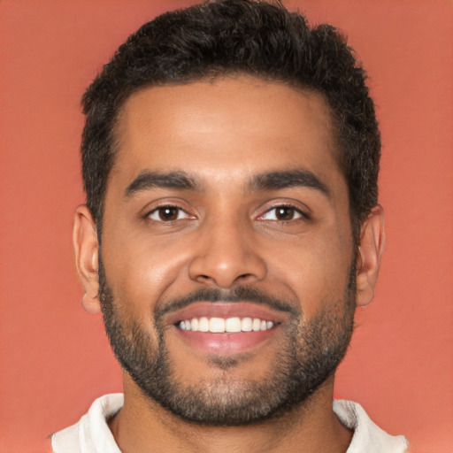 Joyful black young-adult male with short  black hair and brown eyes