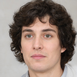 Joyful white young-adult male with medium  brown hair and brown eyes