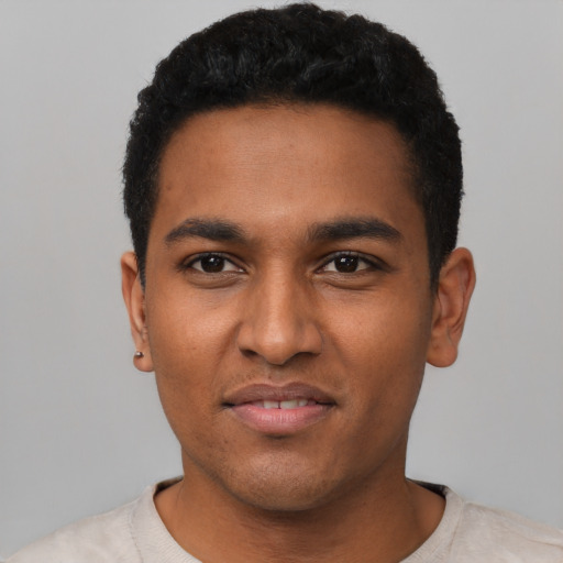 Joyful black young-adult male with short  black hair and brown eyes