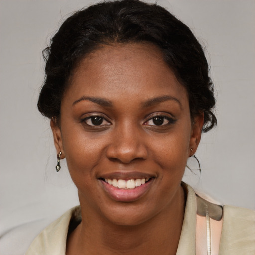 Joyful black young-adult female with medium  brown hair and brown eyes