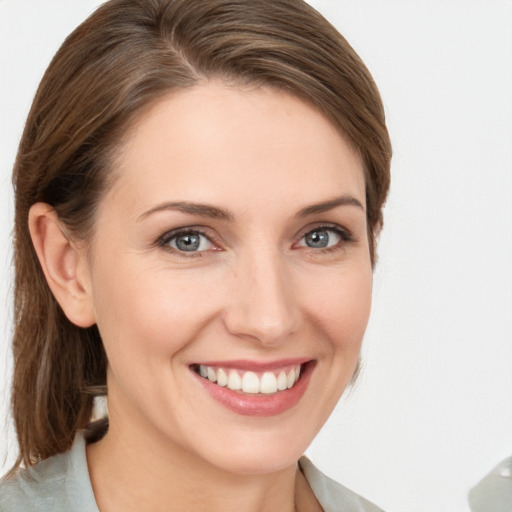 Joyful white young-adult female with medium  brown hair and grey eyes