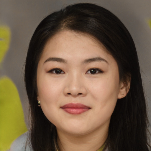 Joyful asian young-adult female with long  brown hair and brown eyes