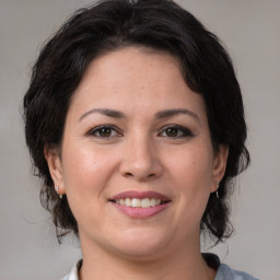 Joyful white adult female with medium  brown hair and brown eyes