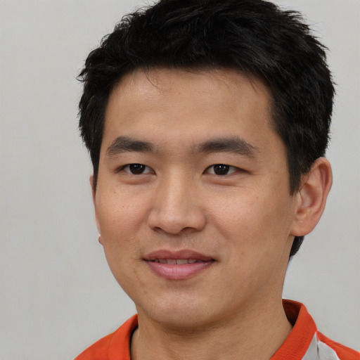 Joyful white young-adult male with short  black hair and brown eyes