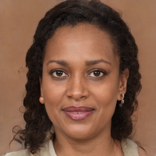 Joyful black young-adult female with medium  brown hair and brown eyes
