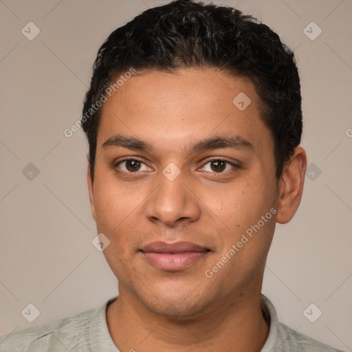 Joyful latino young-adult male with short  black hair and brown eyes