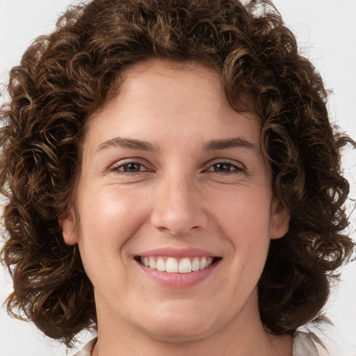 Joyful white young-adult female with medium  brown hair and green eyes