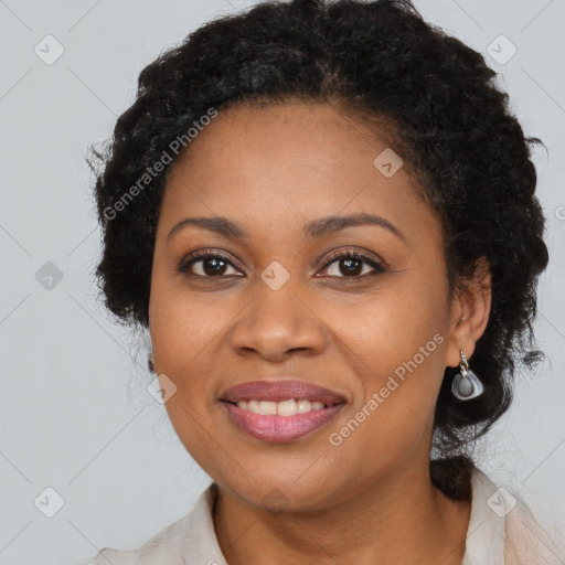 Joyful black young-adult female with long  brown hair and brown eyes