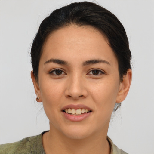 Joyful latino young-adult female with short  brown hair and brown eyes