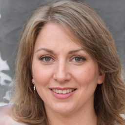 Joyful white adult female with long  brown hair and brown eyes