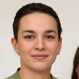 Joyful white young-adult female with short  brown hair and brown eyes