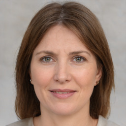 Joyful white adult female with medium  brown hair and grey eyes