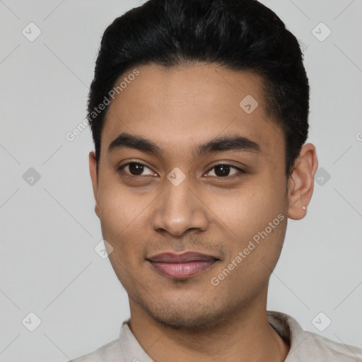 Joyful latino young-adult male with short  black hair and brown eyes