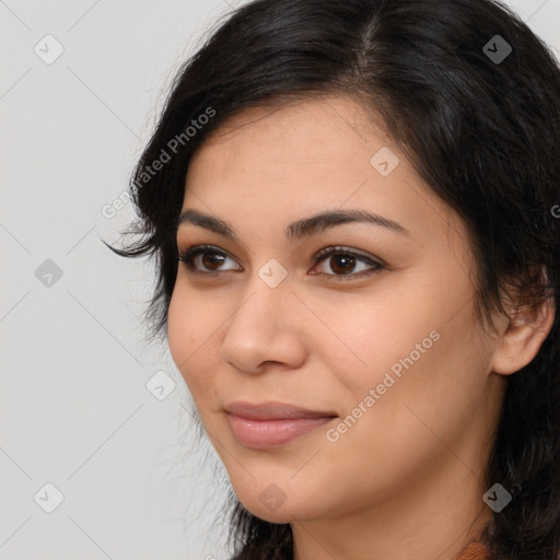 Joyful latino young-adult female with long  brown hair and brown eyes