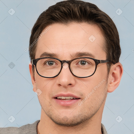 Joyful white young-adult male with short  brown hair and grey eyes