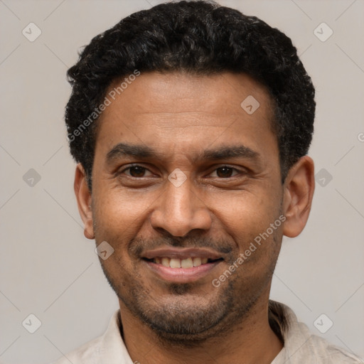 Joyful latino adult male with short  black hair and brown eyes