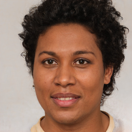 Joyful black young-adult female with short  brown hair and brown eyes