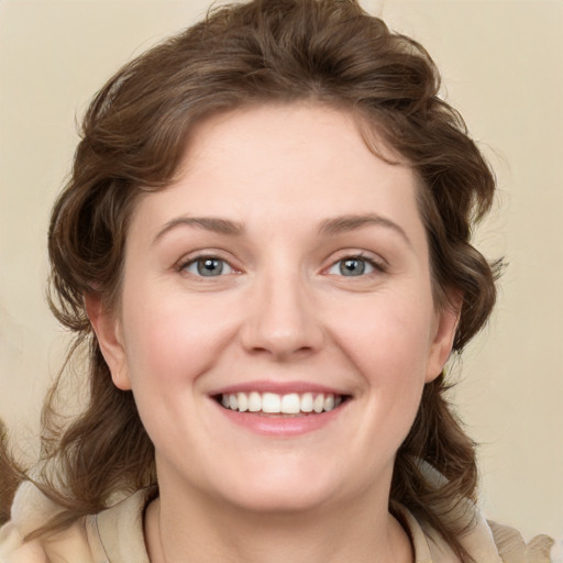 Joyful white young-adult female with medium  brown hair and blue eyes