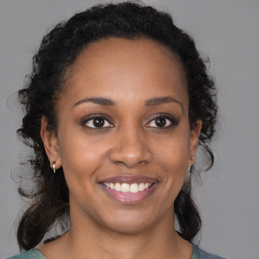 Joyful black young-adult female with medium  brown hair and brown eyes