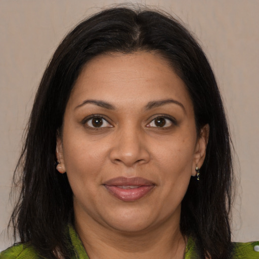 Joyful black adult female with medium  brown hair and brown eyes