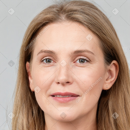 Joyful white adult female with long  brown hair and grey eyes