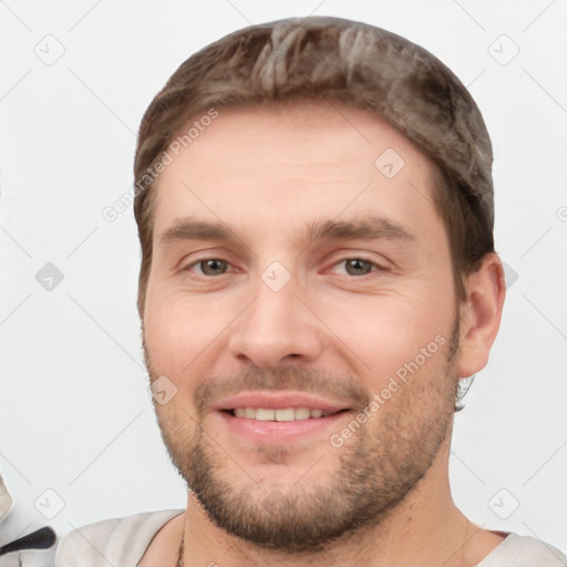 Joyful white young-adult male with short  brown hair and brown eyes