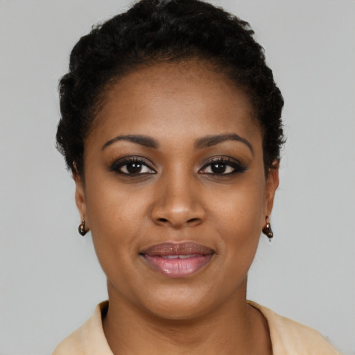 Joyful black young-adult female with short  brown hair and brown eyes