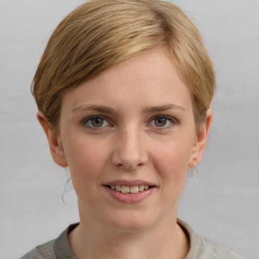 Joyful white young-adult female with short  brown hair and blue eyes