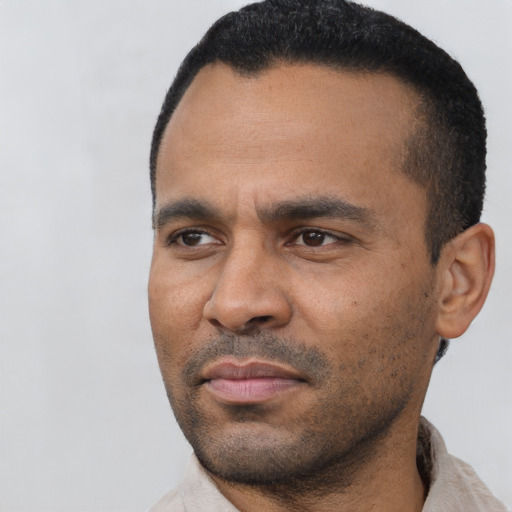 Neutral latino adult male with short  black hair and brown eyes