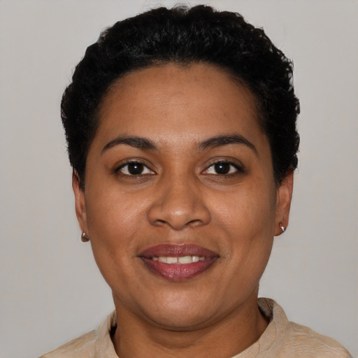 Joyful black young-adult female with short  black hair and brown eyes