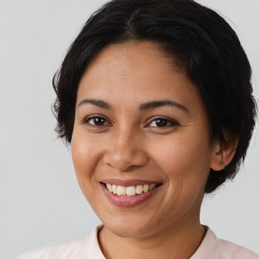 Joyful latino young-adult female with short  brown hair and brown eyes