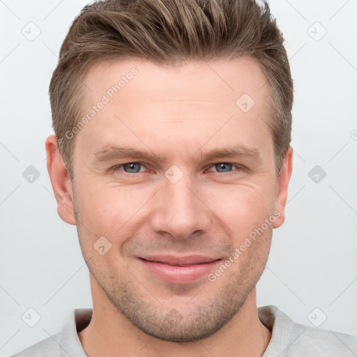 Joyful white adult male with short  brown hair and grey eyes