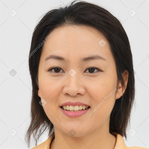 Joyful asian young-adult female with medium  brown hair and brown eyes