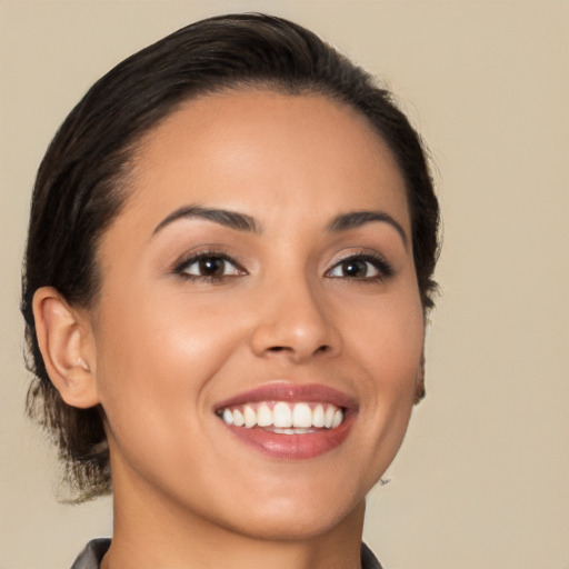 Joyful latino young-adult female with medium  brown hair and brown eyes