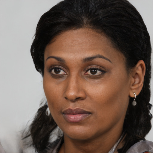 Neutral black young-adult female with long  brown hair and brown eyes