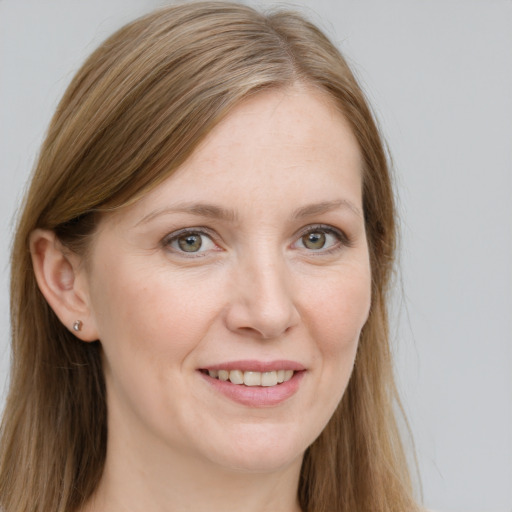 Joyful white young-adult female with long  brown hair and blue eyes