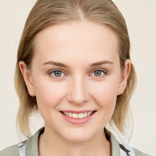 Joyful white young-adult female with medium  brown hair and blue eyes