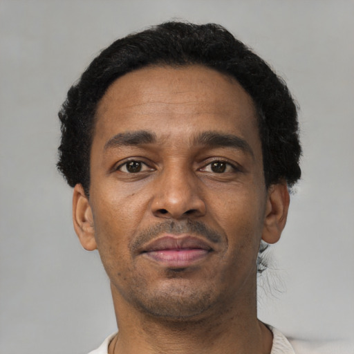 Neutral black adult male with short  black hair and brown eyes