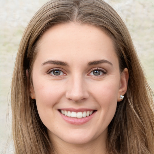 Joyful white young-adult female with long  brown hair and grey eyes