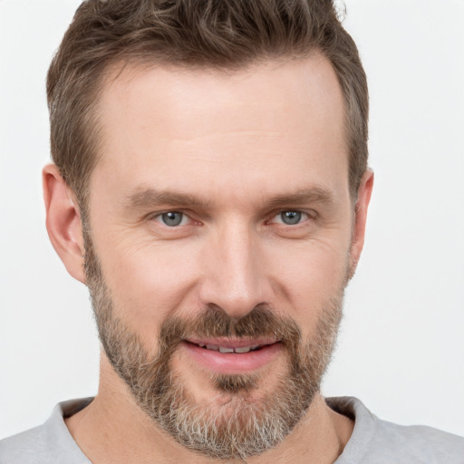 Joyful white adult male with short  brown hair and brown eyes