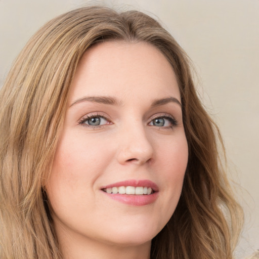 Joyful white young-adult female with long  brown hair and green eyes