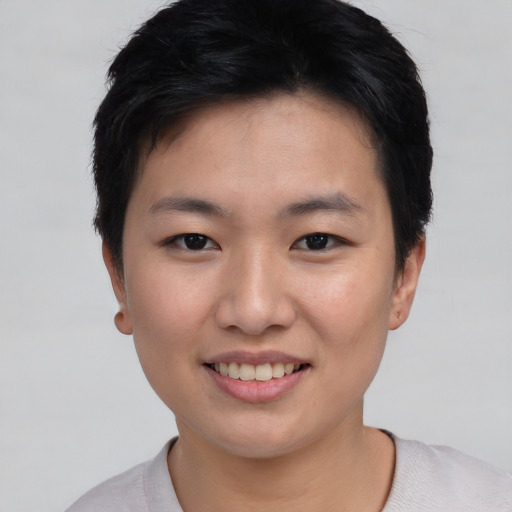 Joyful asian young-adult female with short  brown hair and brown eyes