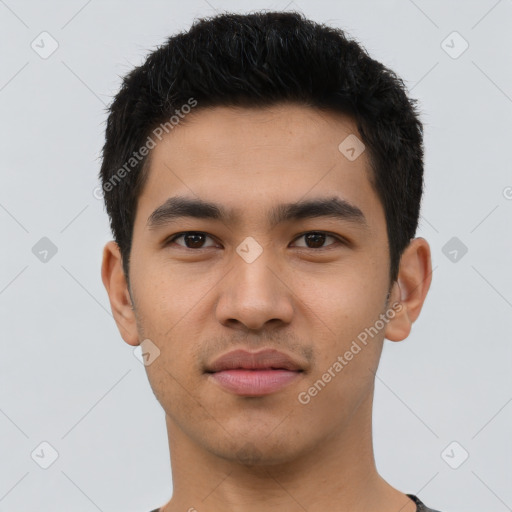 Joyful latino young-adult male with short  black hair and brown eyes