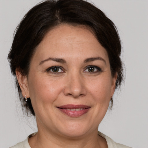 Joyful white adult female with medium  brown hair and brown eyes