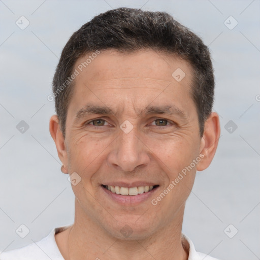 Joyful white adult male with short  brown hair and brown eyes