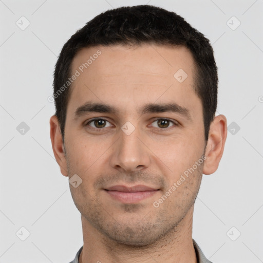 Joyful white young-adult male with short  black hair and brown eyes