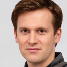 Joyful white young-adult male with short  brown hair and grey eyes