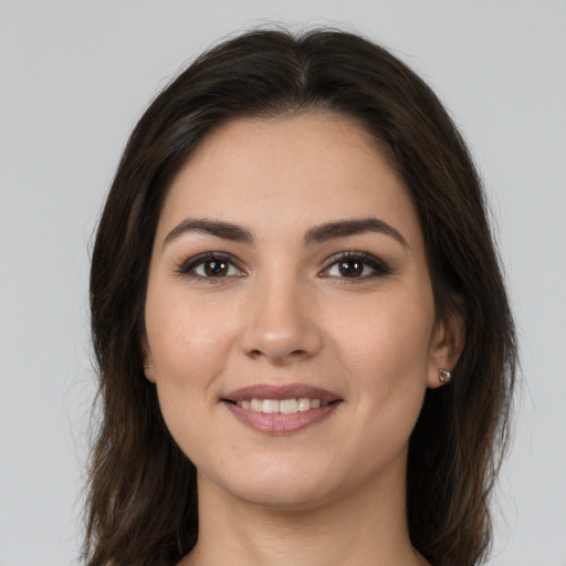 Joyful white young-adult female with long  brown hair and brown eyes