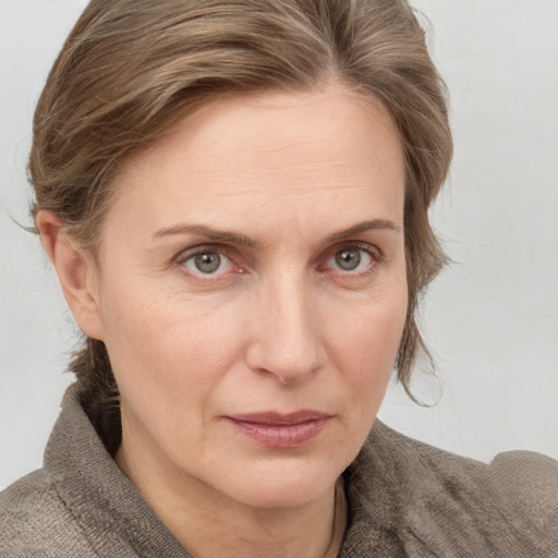 Joyful white adult female with medium  brown hair and grey eyes